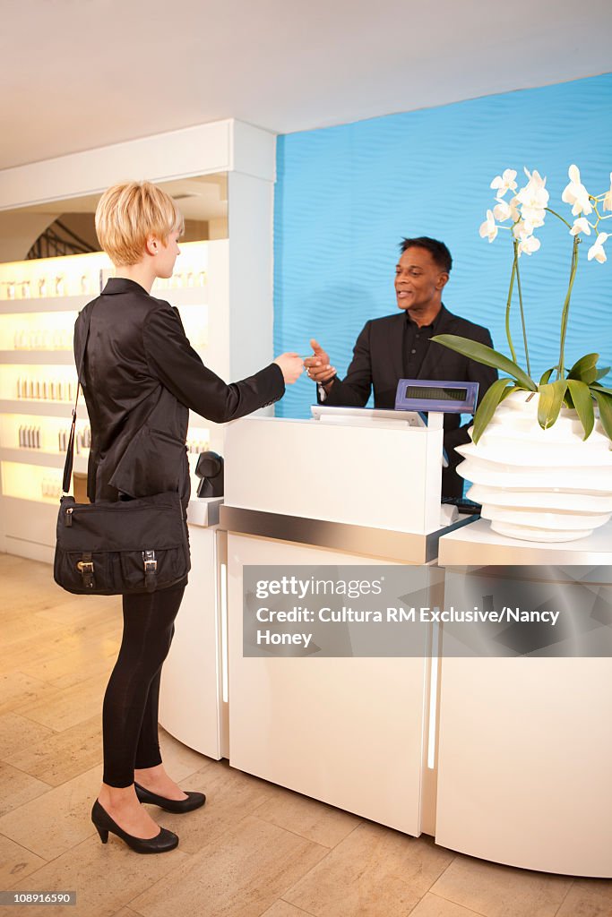 Woman Paying in Shop