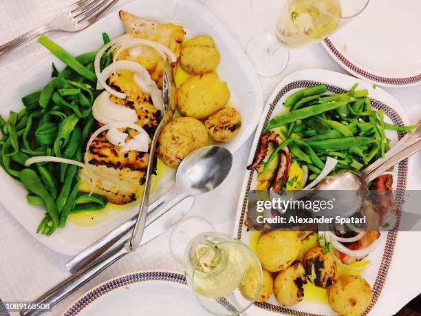 traditional portuguese food - bacalhau (dried cod), octopus, potato and green peas - portugal food stock pictures, royalty-free photos & images