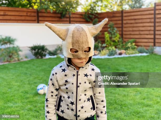 portrait of a boy in a funny horns mask at the back yard - london game 2018 stock pictures, royalty-free photos & images