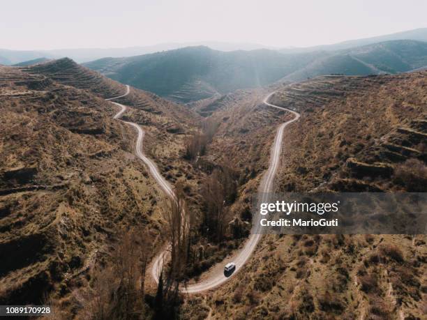 travelling on a winding road - hairpin curve stock pictures, royalty-free photos & images