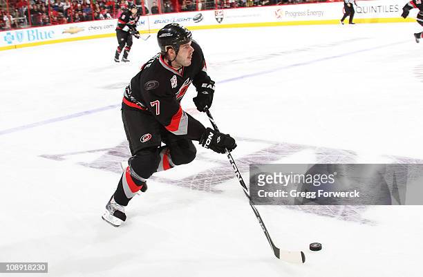 Ian White of the Carolina Hurricanes controls the puck on the ice during an NHL game against the Atlanta Thrashers on February 5, 2011 at RBC Center...