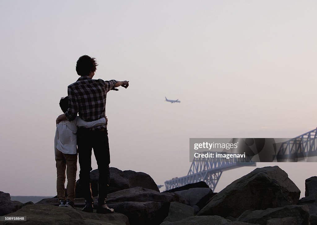 Father and son looking at airplane