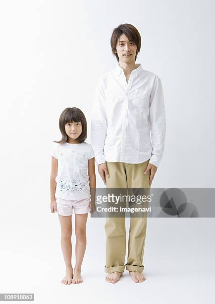 father and daughter standing side by side - asian man barefoot foto e immagini stock