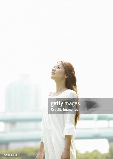 young woman looking up - japanese woman looking up stock pictures, royalty-free photos & images