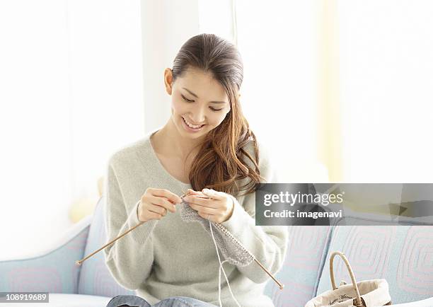 a young woman knitting - 若い女性一人 ストックフォトと画像