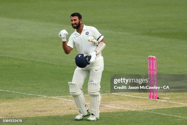 Cheteshwar Pujara of India celebrates after reaching his century during day one of the Fourth Test match in the series between Australia and India at...