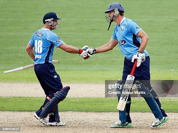 Gareth Hopkins of the Aces congratulates teammate Tim McIntosh after McIntosh scored 150 runs during the one day semi final match between Auckland...