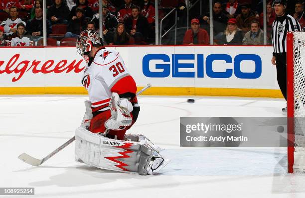 Cam Ward of the Carolina Hurricanes cannot stop the puck as Mattias Tedenby of the New Jersey Devils scores the game winning goal in overtime during...