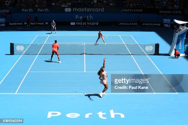Serena Williams of the United States serves in the mixed doubles match against Katie Boulter and Cameron Norrie of Great Britain during day six of...