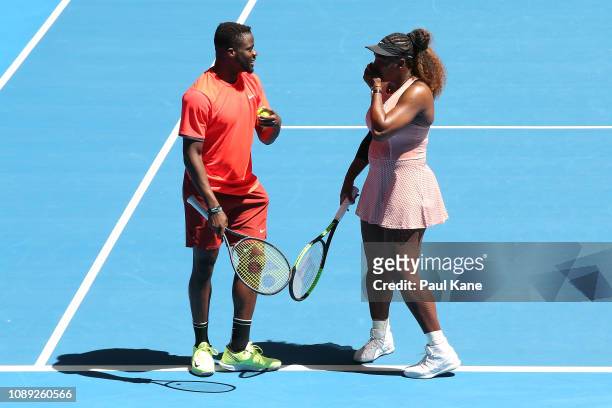 Frances Tiafoe and Serena Williams of the United States talk tactics in the mixed doubles match against Katie Boulter and Cameron Norrie of Great...