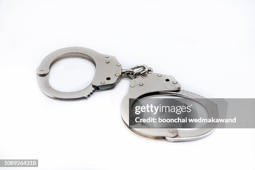 Metal handcuffs against white background. Metal handcuffs against white background.