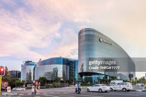 discovery building in sandton city at sunset - sandton johannesburg stock pictures, royalty-free photos & images