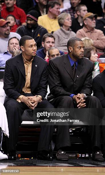 Injured players Brandon Roy and Marcus Camby of the Portland Trail Blazers sit on the bench and watch the game against the Chicago Bulls on February...