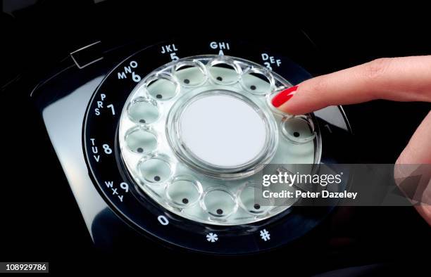 female finger dialling on black retro phone - red nail polish stock pictures, royalty-free photos & images