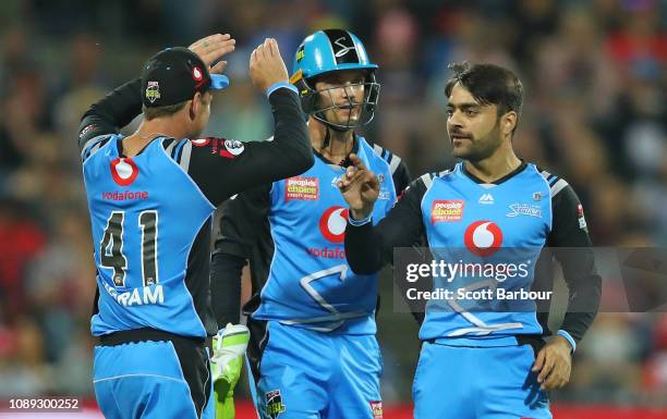 Rashid Khan of the Strikers is congratulated by his teammates after dismissing Cameron White of the Renegades during the Big Bash League match...