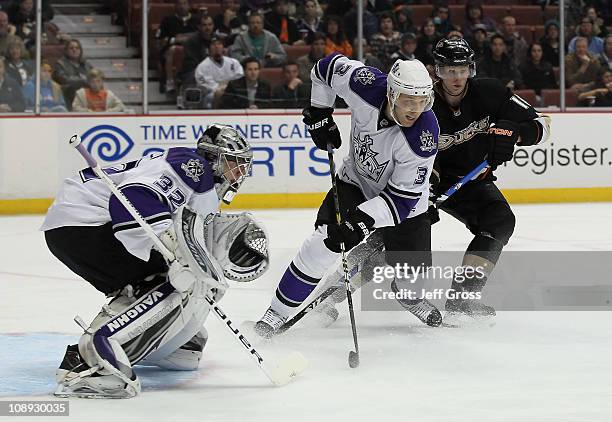 Goaltender Jonathan Quick of the Los Angeles Kings defends his net, as temmate Jack Johnson defends against Corey Perry of the Anaheim Ducks at the...