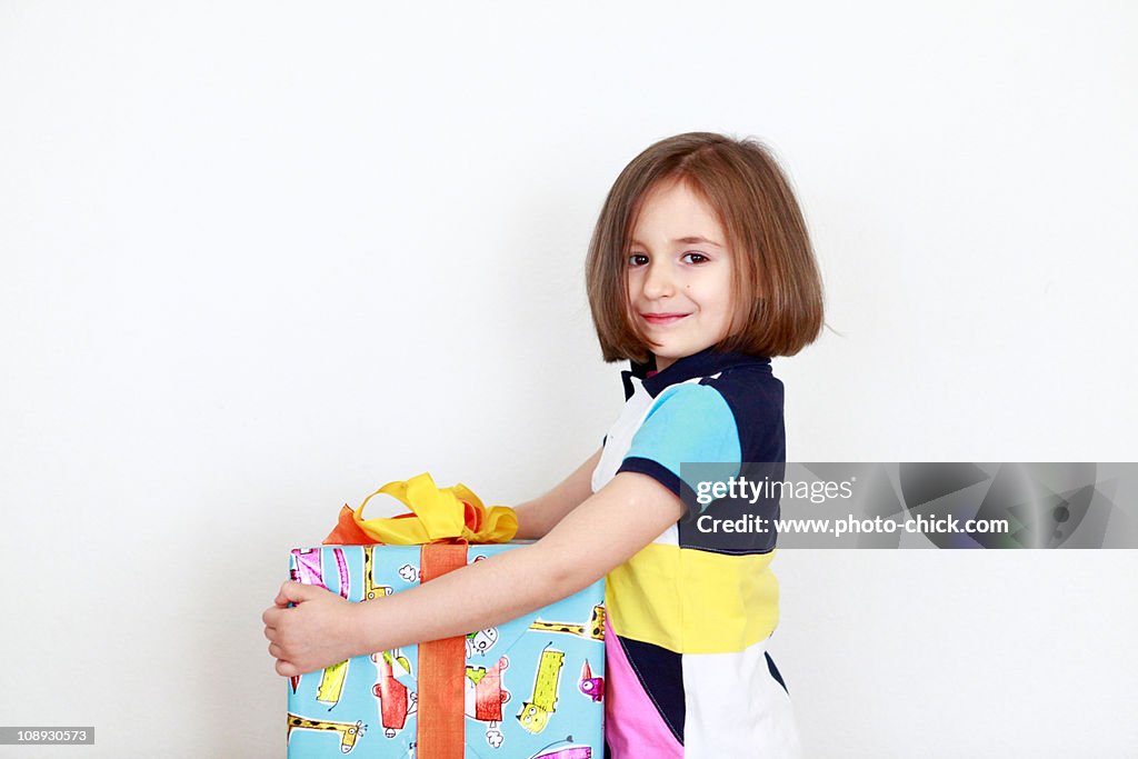 Girl holding a colorful present box