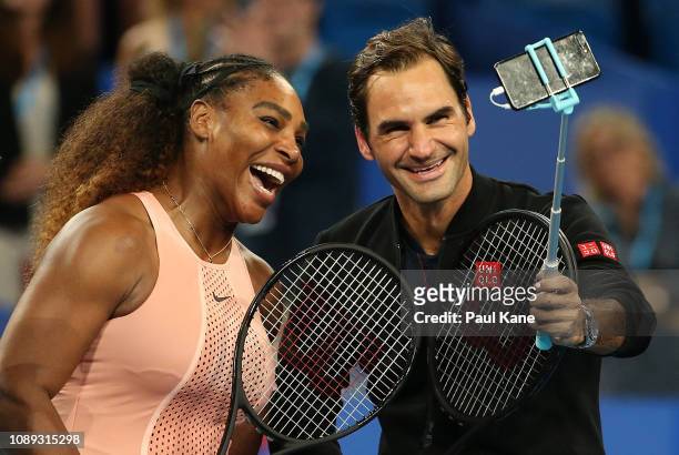 Serena Williams of the United States and Roger Federer of Switzerland take a selfie following their mixed doubles match during day four of the 2019...