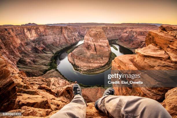 man on top of horseshoe bend - extreme angle stock pictures, royalty-free photos & images