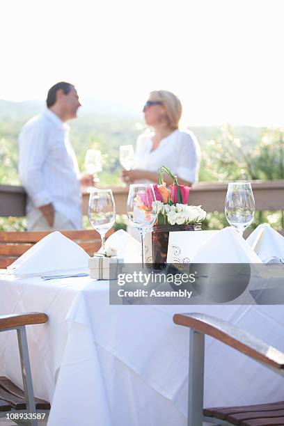couple on a deck at an outdoor celebration - hochzeit schiff reling stock-fotos und bilder
