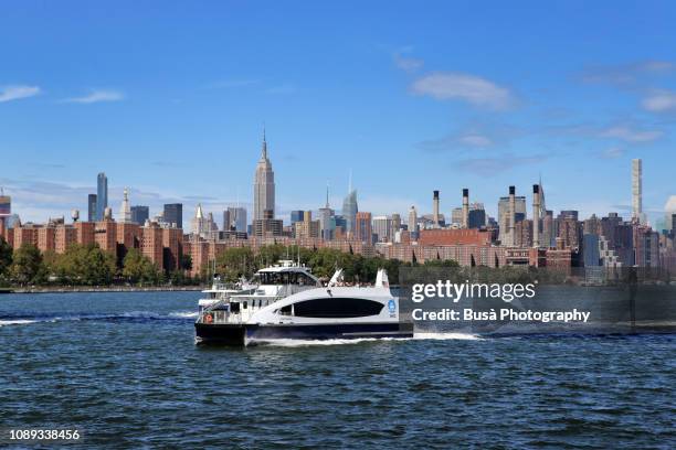 view from the east river of the waterfront of midtown manhattan on a clear sunny day. new york city, usa - フェリー船 ストックフォトと画像