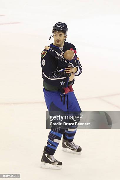 Brent Burns of the Minnesota Wild and Team Lidstrom holds his daughter Peyton after they defeated Team Staal 11 to 10 in the 58th NHL All-Star Game...
