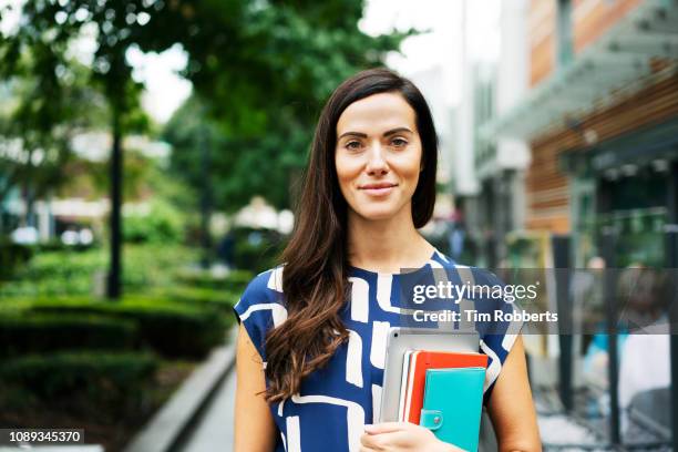 portrait of woman holding items - testimonial portrait smile stock pictures, royalty-free photos & images