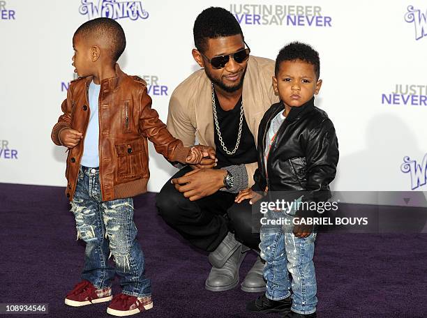 Singer Usher arrives with his children at the premiere of "Justin Bieber: Never say Never in Los Angeles, California on February 8, 2011. AFP PHOTO...