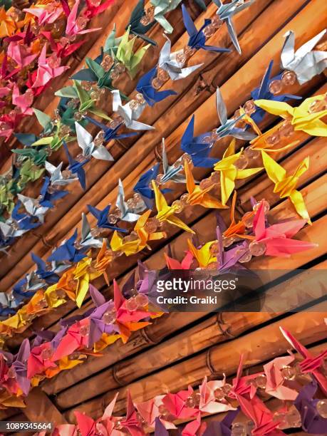 curtain of colorful bird origamis - smartphones dangling stock pictures, royalty-free photos & images
