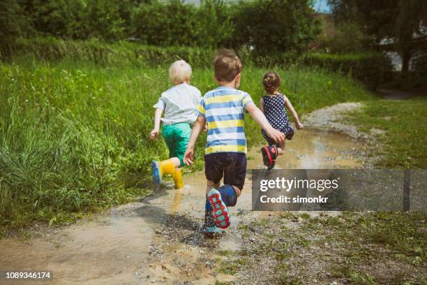 children playing in mud - muddy shoe print stock pictures, royalty-free photos & images