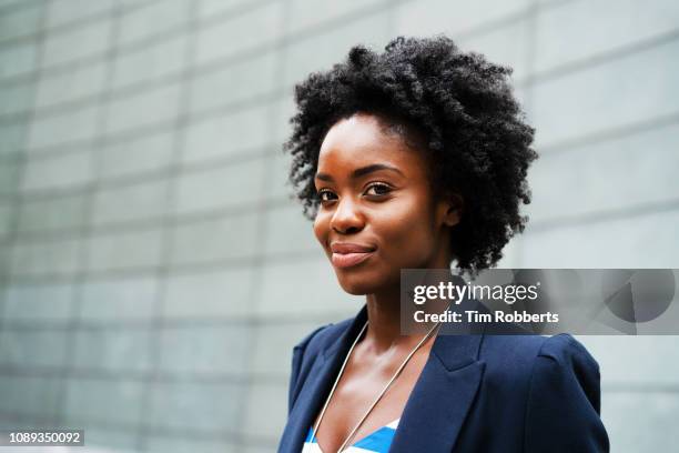 woman looking at camera, smiling - african businesswoman stock pictures, royalty-free photos & images