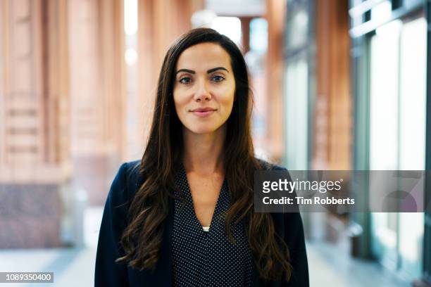 confident woman looking at camera - corporate business woman stock pictures, royalty-free photos & images