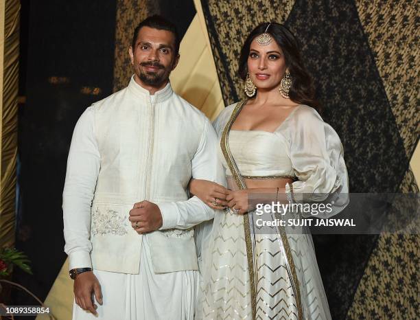 Indian Bollywood actors Karan Singh Grover and Bipasha Basu pose for a picture during the wedding reception of film producer Mukesh Bhatt's daughter...