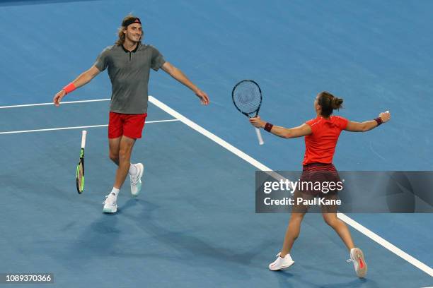 Stefanos Tsitsipas and Maria Sakkari of Greece celebrate winning their mixed doubles match against Roger Federer and Belinda Bencic of Switzerland...