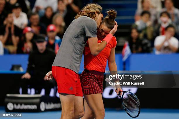 Maria Sakkari and Stefanos Tsitsipas of Greece embrace after defeating Belinda Bencic and Roger Federer of Switzerland in the mixed doubles match...