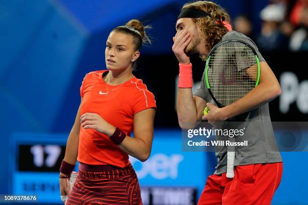 Maria Sakkari and Stefanos Tsitsipas of Greece talk tactics in the mixed doubles match against Belinda Bencic and Roger Federer of Switzerland during...