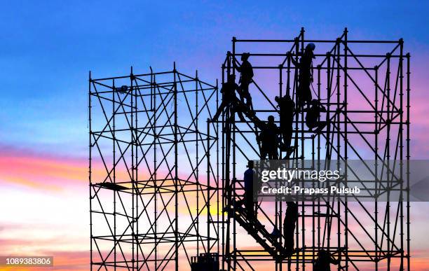 labor day commands silhouette engineers stand for construction teams to work in heavy industry, high ground and safety concepts over natural color pencils that blur the background. - scaffolding stock pictures, royalty-free photos & images