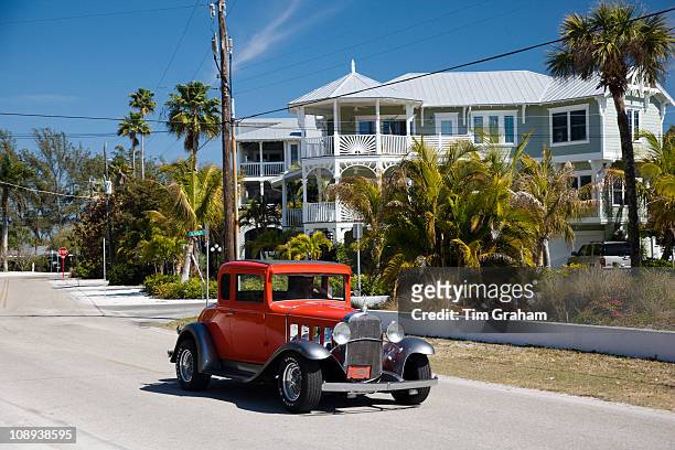 Vintage classic automobile, Chevrolet modelled, and luxury homes at vacation resort of Anna Maria Island, Florida, USA