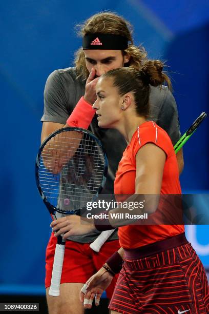 Maria Sakkari and Stefanos Tsitsipas of Greece talk tactics in the mixed doubles match against Belinda Bencic and Roger Federer of Switzerland during...