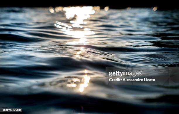 surface of water of a lake - water surface fotografías e imágenes de stock