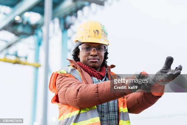 african-american woman working at shipping port - black glove stock pictures, royalty-free photos & images