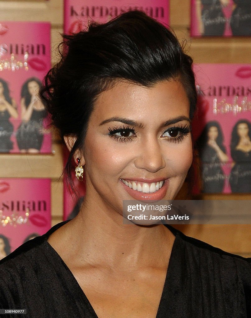 Kourtney And Khloe Kardashian Sign Copies Of "Kardashian Konfidential"