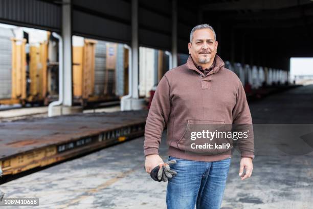 manual worker standing outdoors at shipping port - blue collar portrait imagens e fotografias de stock