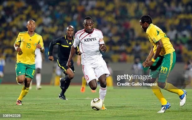 Dennis Oliech of Kenya runs between South African players during the International friendly match between South Africa and Kenya at Royal Bafokeng...