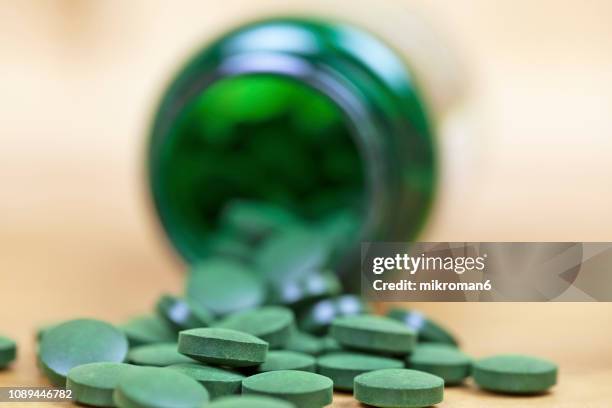 organic spirulina (blue-green algae) - antioxidant pill stock pictures, royalty-free photos & images