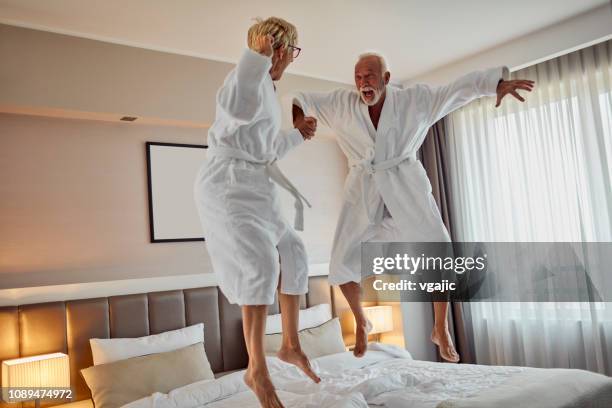 älteres paar in einem hotel - old couple jumping stock-fotos und bilder