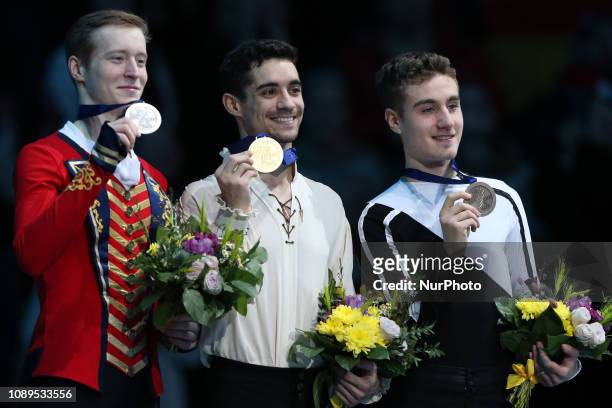 Second placed Russia's Alexander Samarin, winner Spain's Javier Fernandez and third placed Italy's Matteo Rizzo during podium ceremony after the Men...