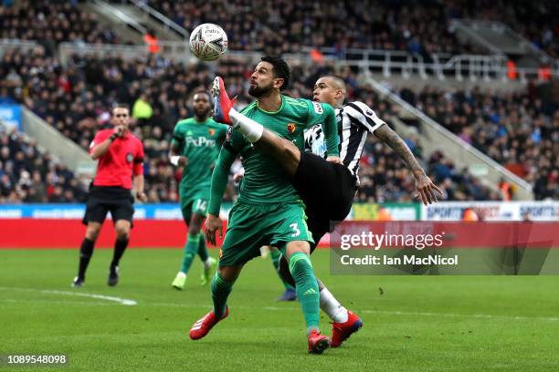 Miguel Britos of Watford is challenged by Kenedy of Newcastle United during the FA Cup Fourth Round match between Newcastle United and Watford at St...