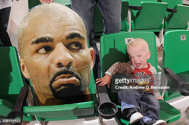 Jace Iverson a young fan of the Utah Jazz cries next to the head sign of Carlos Boozer of the Chicago Bulls at EnergySolutions Arena on February 9,...
