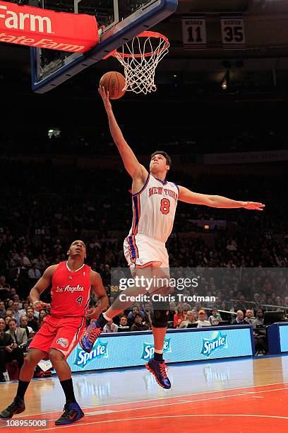 Danilo Gallinari of the New York Knicks lays the ball up over Randy Foye of the Los Angeles Clippers at Madison Square Garden on February 9, 2011 in...